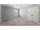Spacious bedroom features neutral carpet, ceiling fan, and window at 1348 Ewing Creek Dr, Dacula, GA 30019