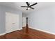 Bedroom featuring hardwood floors, light blue walls, closet, and doorways at 1348 Ewing Creek Dr, Dacula, GA 30019