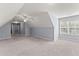 Large bedroom with neutral carpet, light blue walls, and ample natural light from a window at 1348 Ewing Creek Dr, Dacula, GA 30019