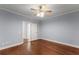Bedroom featuring hardwood floors, light blue walls, and doorway at 1348 Ewing Creek Dr, Dacula, GA 30019