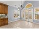 Bright dining area with tile floors, large windows, and access to an outdoor patio at 1348 Ewing Creek Dr, Dacula, GA 30019