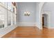 Light-filled dining room boasting hardwood floors, elegant wainscoting, and a modern chandelier at 1348 Ewing Creek Dr, Dacula, GA 30019