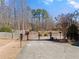 Gated driveway leading to a spacious lot with mature trees, offering privacy and a serene setting at 1348 Ewing Creek Dr, Dacula, GA 30019