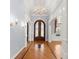 Elegant foyer with hardwood floors, decorative columns, and a stunning chandelier at 1348 Ewing Creek Dr, Dacula, GA 30019