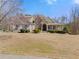 Attractive home with a well-maintained lawn, inviting entrance, and traditional design elements at 1348 Ewing Creek Dr, Dacula, GA 30019