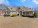 Stunning brick home featuring manicured landscaping, a covered porch, and classic architectural details at 1348 Ewing Creek Dr, Dacula, GA 30019