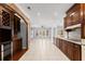 Open kitchen with custom cherry cabinets and a stone archway, with modern appliances at 1348 Ewing Creek Dr, Dacula, GA 30019