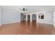 Open living room with hardwood floors and archways at 1348 Ewing Creek Dr, Dacula, GA 30019