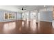 Open-concept living room featuring hardwood floors and archways at 1348 Ewing Creek Dr, Dacula, GA 30019
