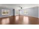 Large living room with hardwood floors and abundant natural light at 1348 Ewing Creek Dr, Dacula, GA 30019