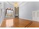 This stunning living room boasts a stone fireplace, hardwood floors, and a beautiful chandelier at 1348 Ewing Creek Dr, Dacula, GA 30019