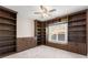 Cozy office with custom built-in bookshelves and cabinets, offering ample storage and a dedicated workspace at 1348 Ewing Creek Dr, Dacula, GA 30019