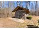 Charming shed with lattice walls nestled in a secluded part of the backyard surrounded by a black fence at 1348 Ewing Creek Dr, Dacula, GA 30019