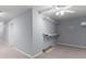 Unfinished storage area with shelving, grey walls, and carpet at 1348 Ewing Creek Dr, Dacula, GA 30019