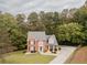 Picturesque aerial view of a home with lush green surroundings and a long driveway at 3500 Parkwood Hills Ct, Snellville, GA 30078