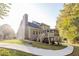 Rear view of a two-story home with a screened-in porch and a walk-out basement at 3500 Parkwood Hills Ct, Snellville, GA 30078