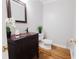Stylish powder room with a dark wood vanity, decorative mirror, and modern fixtures at 3500 Parkwood Hills Ct, Snellville, GA 30078
