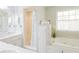 Bright bathroom featuring a large bathtub, shower, and double sinks at 3500 Parkwood Hills Ct, Snellville, GA 30078