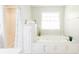 Bright bathroom featuring a large bathtub, shower, and bright lighting at 3500 Parkwood Hills Ct, Snellville, GA 30078