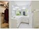 Well-lit bathroom offering double sinks, large mirrors, a walk-in closet, and modern fixtures at 3500 Parkwood Hills Ct, Snellville, GA 30078