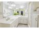 Bright bathroom featuring double sinks, large mirrors, and white cabinetry at 3500 Parkwood Hills Ct, Snellville, GA 30078