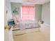 Bright bedroom with pale green walls, carpeted floors, and a cozy bed at 3500 Parkwood Hills Ct, Snellville, GA 30078