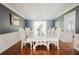 Elegant dining room with a large white table, decorative chairs, and stylish decor at 3500 Parkwood Hills Ct, Snellville, GA 30078