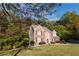 A beautiful two-story brick home with black shutters and a well-manicured lawn at 3500 Parkwood Hills Ct, Snellville, GA 30078