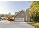 Exterior view of the home featuring the attached garage and well-maintained landscaping at 3500 Parkwood Hills Ct, Snellville, GA 30078