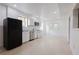 White kitchen features stainless appliances, granite countertops, and a black refrigerator at 3500 Parkwood Hills Ct, Snellville, GA 30078