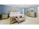 Spacious main bedroom boasts a decorative headboard, ample natural light, and neutral color palette at 3500 Parkwood Hills Ct, Snellville, GA 30078