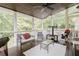 Relaxing screened-in porch with ceiling fan and comfortable seating, perfect for enjoying the outdoors at 3500 Parkwood Hills Ct, Snellville, GA 30078