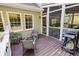 View of the deck leading to the screened-in porch with outdoor seating and grilling area at 3500 Parkwood Hills Ct, Snellville, GA 30078