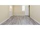 Room featuring modern gray wood floors, white trim, and natural light at 3500 Parkwood Hills Ct, Snellville, GA 30078