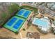 Aerial view of community pool, tennis courts, playground and surrounding neighborhood at 650 Village Crest Dr, Suwanee, GA 30024