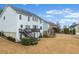 Large backyard featuring a spacious deck, staircase and landscaped lawn at 650 Village Crest Dr, Suwanee, GA 30024