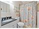 Cozy bathroom with granite counters, framed mirror and patterned shower curtain at 650 Village Crest Dr, Suwanee, GA 30024