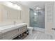 Modern bathroom with a large vanity, shelving, and a glass shower at 650 Village Crest Dr, Suwanee, GA 30024