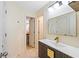 Modern bathroom with a sleek vanity, tile floors, and access to the laundry room at 650 Village Crest Dr, Suwanee, GA 30024