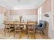Bright dining room features wainscoting, shuttered windows, and modern chandelier at 650 Village Crest Dr, Suwanee, GA 30024