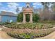 Charming community entrance sign with colorful flowers and landscaping at 650 Village Crest Dr, Suwanee, GA 30024
