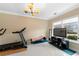 Bright exercise room with large window, treadmill, and modern ceiling light at 650 Village Crest Dr, Suwanee, GA 30024