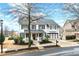 Charming two-story home with a well-manicured lawn and a welcoming front porch at 650 Village Crest Dr, Suwanee, GA 30024