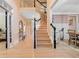 Spacious foyer with hardwood floors, staircase, and view into adjacent dining room at 650 Village Crest Dr, Suwanee, GA 30024