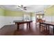 Spacious recreation room with billiard table, hardwood flooring and stylish chandelier at 650 Village Crest Dr, Suwanee, GA 30024