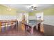 Entertaining game room with pool table, chandelier, and easy access to exercise room at 650 Village Crest Dr, Suwanee, GA 30024