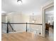 Hallway boasts hardwood floors, white trim, and staircase access, providing a bright and airy feel at 650 Village Crest Dr, Suwanee, GA 30024