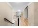 Well-lit hallway showcases hardwood floors and access to multiple rooms with neutral paint and white trim at 650 Village Crest Dr, Suwanee, GA 30024