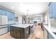 Open-concept kitchen features large island, adjacent to the living area, creating an inviting and cohesive space at 650 Village Crest Dr, Suwanee, GA 30024