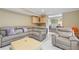 Comfortable living area with large leather sectional, wet bar, and tile floors at 650 Village Crest Dr, Suwanee, GA 30024